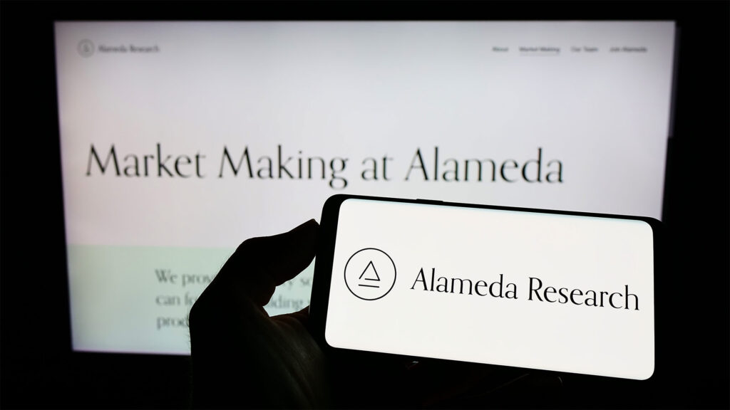 Crypto investment company, Alameda Research on screen in front of web page. Sumber: Shutterstock.